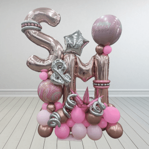 A beautiful balloon sculpture featuring rose gold and pink balloons arranged to form initials, creating an elegant and personalized decoration